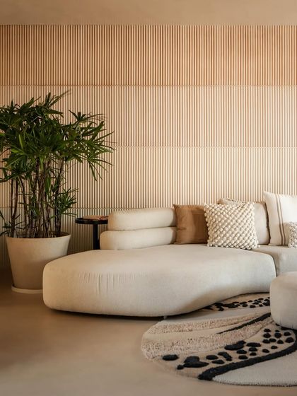 A detail shot of the custom-designed sofa and fluted wall in the "House of Mousse." We focus on creating a sense of continuity, where the eye and body can move effortlessly from one room to the next.
