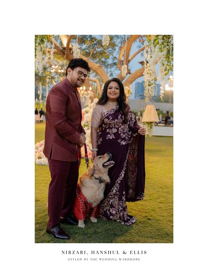 A formal portrait of Nirzari, Hanshul, and their dog Ellis, a perfect family picture.