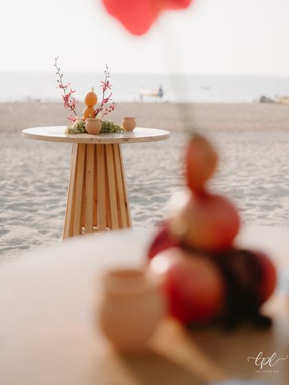 Another view of the cocktail table on the beach, with the ocean in the background.