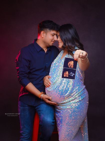 A close-up shot of the couple holding their ultrasound pictures. The focus on the scans makes the baby the star of this glamorous shot.