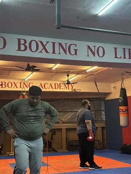 A moment to catch a breath before the next round. The motto on the wall, "NO BOXING NO LIFE," is the philosophy we live by in our academy.