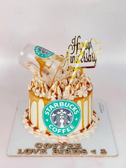 For the coffee-loving love birds! This fun Starbucks-themed anniversary cake features a gravity-defying coffee spill, caramel drizzle, and the iconic green logo.