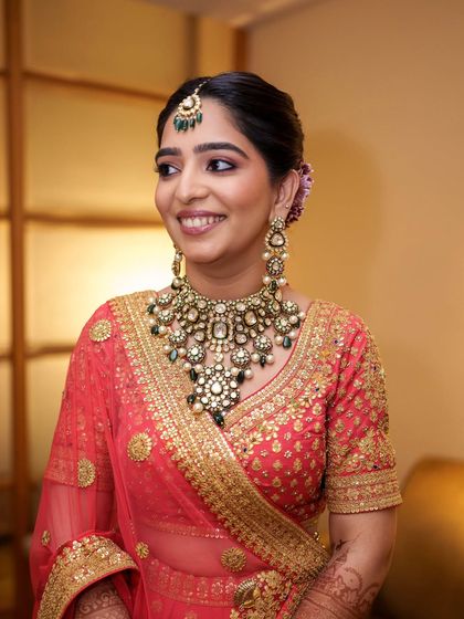 Another beautiful shot of Sanya, showcasing how the soft pink lip and defined eyes work in harmony with her coral lehenga.