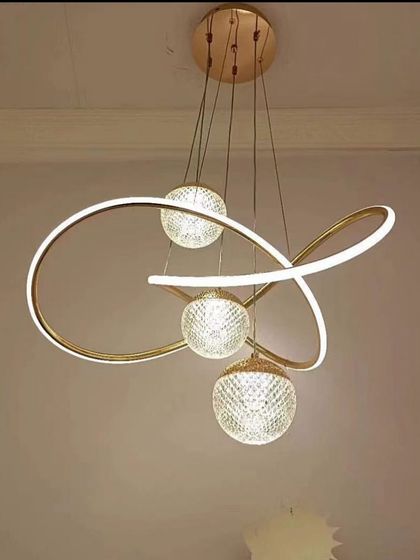 A new addition to my collection, this modern LED pendant combines a flowing, sculptural light band with three crystal-cut globes. It provides a beautiful blend of ambient and decorative light, suitable for a stylish dining area.