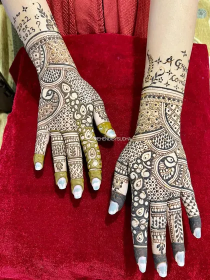 A different view of the back of the hands, showing the intricate patterns that complement the baby shower theme on the front.