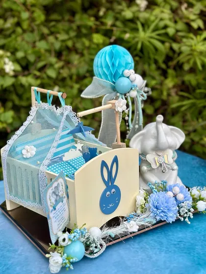 Presenting a most adorable concept for a baby announcement. This platter features a miniature baby cot and our bestselling little peanut elephant jar, all in a lovely blue theme.