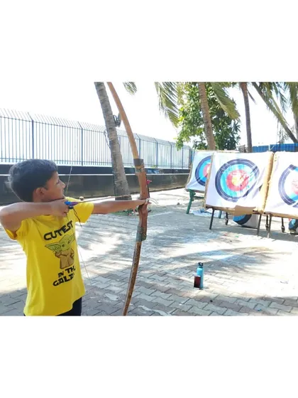 This little archer is focused on popping the balloons. It's a favorite activity for all our students.