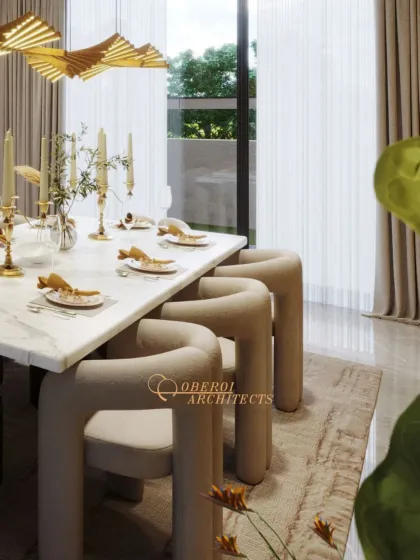 A close-up of the dining setup, featuring unique, modern chairs with a curved, continuous form that is both artistic and comfortable. The table is set for an elegant meal.