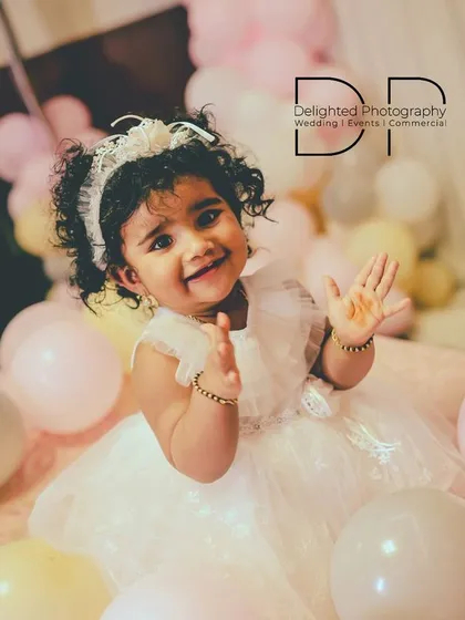 A portrait from a first birthday photoshoot, capturing a beautiful, happy expression. I aim to make these sessions fun for the little ones, resulting in genuine smiles and sparkling eyes.