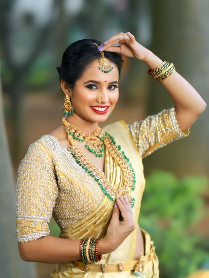 Adjusting the maang tikka from one of our complete bridal sets. We provide all the essential pieces to ensure you look flawless from every angle on your big day.