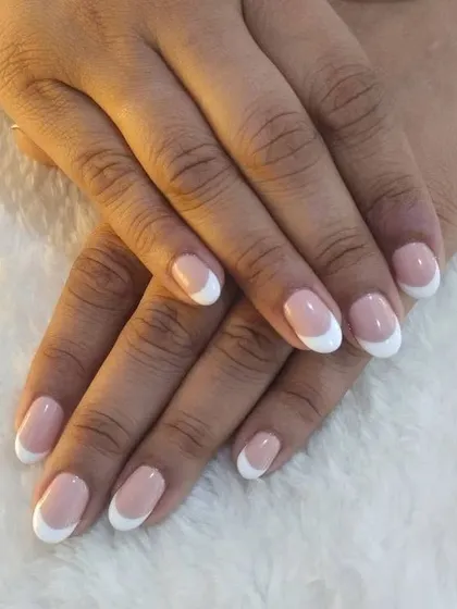 A full view of the classic French manicure on natural nails, showcasing the clean and polished final look.