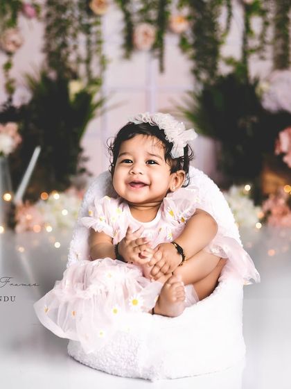 The pure joy of a six-month-old. This baby's smile lights up the entire frame in this beautiful, floral-themed sitter session.