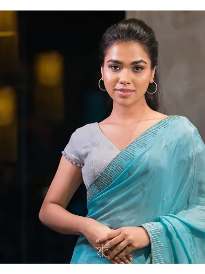 An arctic blue georgette saree that exudes modern allure. The saree is adorned with intricate silver glass bead embroidery for a touch of sparkle.