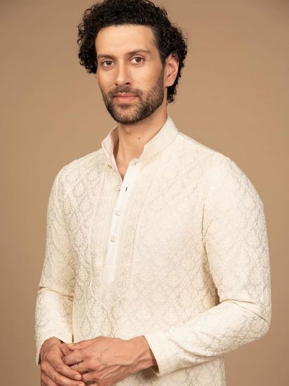 A closer view of the ivory kurta, highlighting the texture and detail of the embroidery. This is a piece that showcases unparalleled craftsmanship.