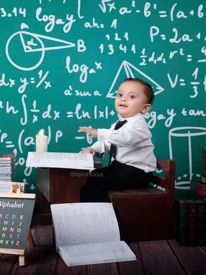 This little scholar is ready to solve some equations. Our "Tiny Mathematician" theme features a chalkboard full of formulas, books, and a globe for a smart and fun photoshoot.