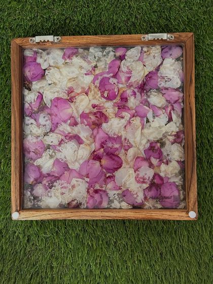 This is the back of the preservation frame, showing the bed of preserved petals before the final resin pour. It's a little glimpse into the careful process of arranging each flower.