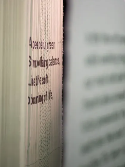 A close-up of text printed on layered fabric for the 'Cherish' installation. This detail highlights our belief that every element, from the choice of font to the texture of the material, contributes to the overall narrative of an exhibit.