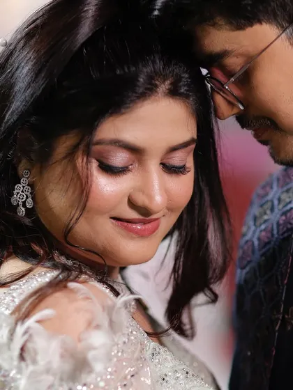 An intimate moment between the couple. The soft pink eyeshadow and dewy skin create a romantic and dreamy look for the bride.