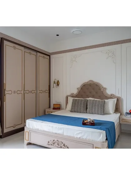 The bedroom layout includes beautifully crafted wardrobes with custom handles and detailing that echoes the Victorian theme. The neutral color palette keeps the space feeling calm and airy.