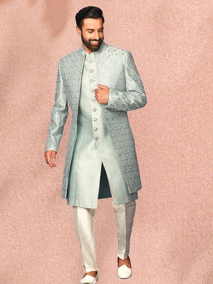 A full-length view of the layered powder blue sherwani. The color is perfect for daytime events and offers a fresh alternative to traditional ivories and golds.