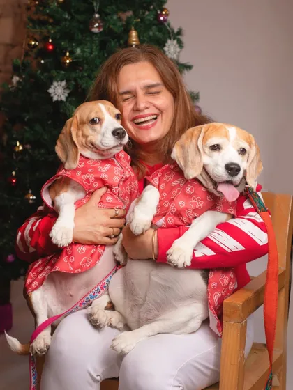 The pure joy of the holiday season is captured in this shot of a pet parent laughing while cuddling her two festive beagles. These are the heartwarming family moments I live to capture.