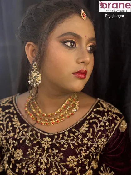 A close-up portrait that captures the elegance of the layered necklace and matching earrings.