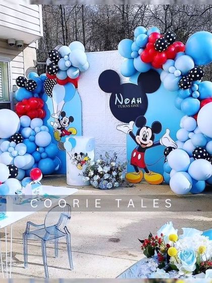 Oh boy! A classic Mickey Mouse party is always a hit. This fun setup uses Mickey's iconic colors with blue, red, and polka-dotted balloons, along with character cutouts for a timeless birthday celebration.