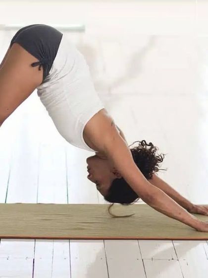The Downward-Facing Dog pose, shown here, is excellent for calming the nervous system. It provides a gentle inversion that increases blood flow to the brain, helping to relieve stress and mild depression.