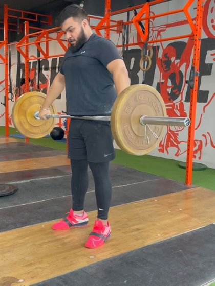 The hang position is a versatile tool for building strength and technique. These images capture various members in the hang start position for the snatch, a stance that increases time under tension and reinforces a powerful pull.