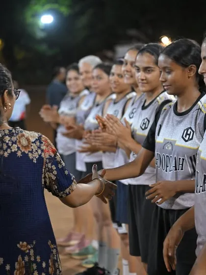 A women's team lines up for post-game handshakes, a great display of sportsmanship.
