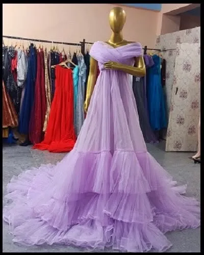 A front view of our lavender ruffled gown on a mannequin. The off-the-shoulder design and tiered skirt create a beautiful and flattering silhouette.