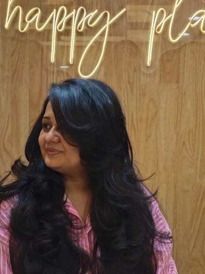 The side view highlights the soft, cascading layers that give this long hairstyle its incredible volume and shape.