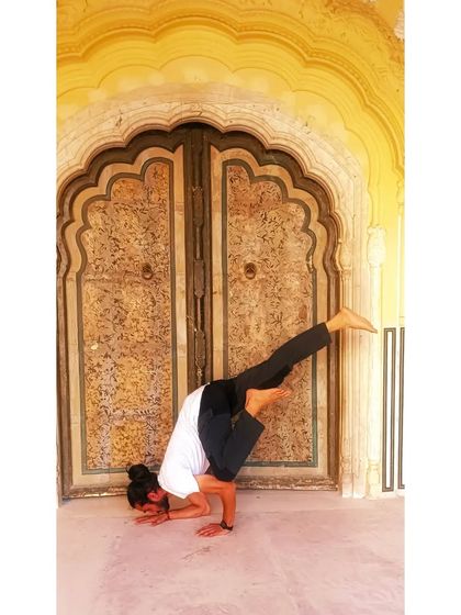 A variation of Bakasana (Crane Pose) in front of a beautiful, ornate door in Jaipur.