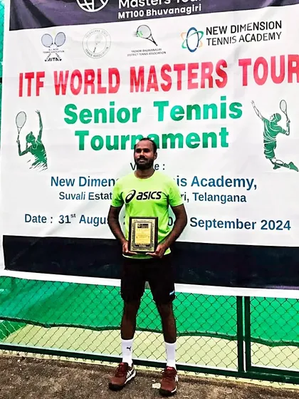 Posing with my singles title award at the senior tennis tournament in Telangana.