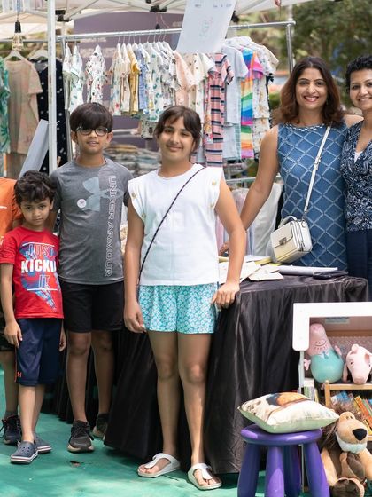 A happy family posing with one of our vendors. These connections are what make the market special. It's a community of parents, kids, and creators.