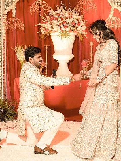 The quintessential engagement photo. We capture the groom down on one knee, proposing to his bride against a beautifully decorated floral backdrop.