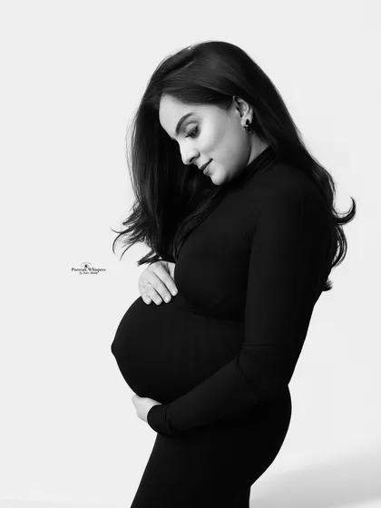 A classic and timeless black and white solo portrait. This minimalist style focuses purely on the beautiful silhouette and the intimate bond between mother and baby, creating an image that will never go out of style.