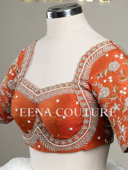 My signature Katori blouse in a festive burnt orange. This piece features contemporary silver and white floral embroidery on the sleeves, with delicate pearl detailing scattered across the body for a touch of bling.