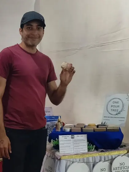A supporter holding up one of my soaps at the Hasta Rachana Fair.