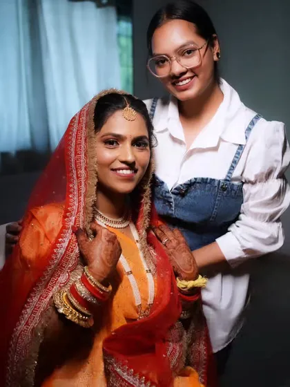 A behind-the-scenes photo of me with the bride, ensuring every detail is perfect before she walks down the aisle.