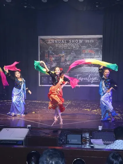 We use props like colorful scarves to add a dynamic visual element to our folk dance routines, creating beautiful patterns as the dancers move.