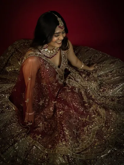 An overhead shot from the same bridal session, showcasing the intricate details of the lehenga. Our spacious setup allows for diverse angles and creative compositions.
