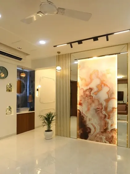 A full view of the common wash basin area, designed to be both functional and beautiful. It features a stunning backlit onyx-style panel that slides to reveal a mirror, decorative niches, and elegant lighting.