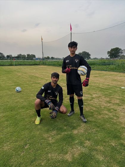 Our goalkeepers are the last line of defense. Here, two of our keepers pose during a specialized training session, ready to command the box.