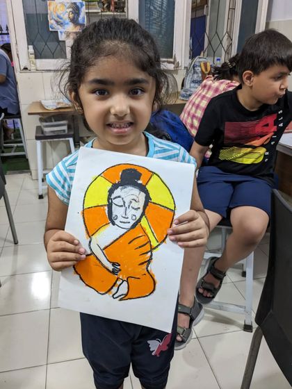 Our student Uvika with her serene and colorful drawing of Buddha. We introduce various cultural themes to inspire our young artists.