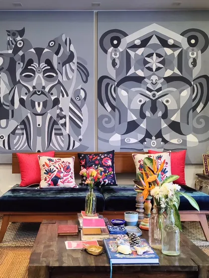 The living area of our studio, featuring large-scale monochrome canvases that contrast with our colorful decor.