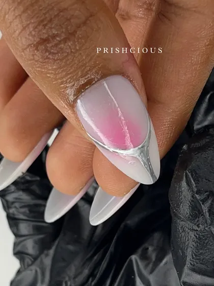 The perfect finish makes all the difference. This nail shows a pink aura base with a unique silver chrome design dripped over the tip for a futuristic vibe.
