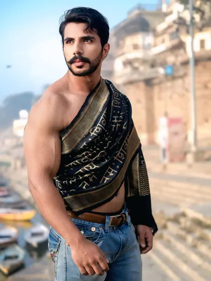 A profile portrait capturing a moment of quiet strength, with the soft light of the ghats creating a timeless, painterly effect.