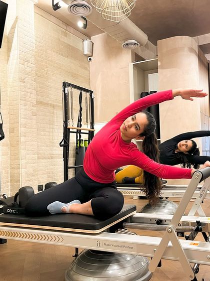 The mermaid stretch on the Reformer is a beautiful way to open up the side body and improve spinal flexibility. Our clients move in perfect sync.