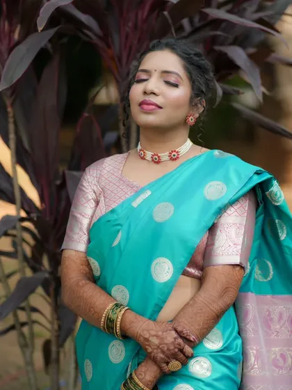 A serene portrait of the bride, her eyes closed, showcasing the soft pink eyeshadow.